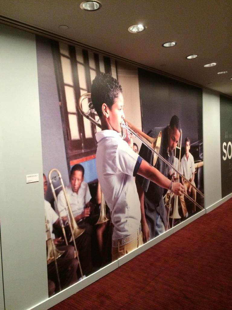 A picture of a kid playing trombone in the wall